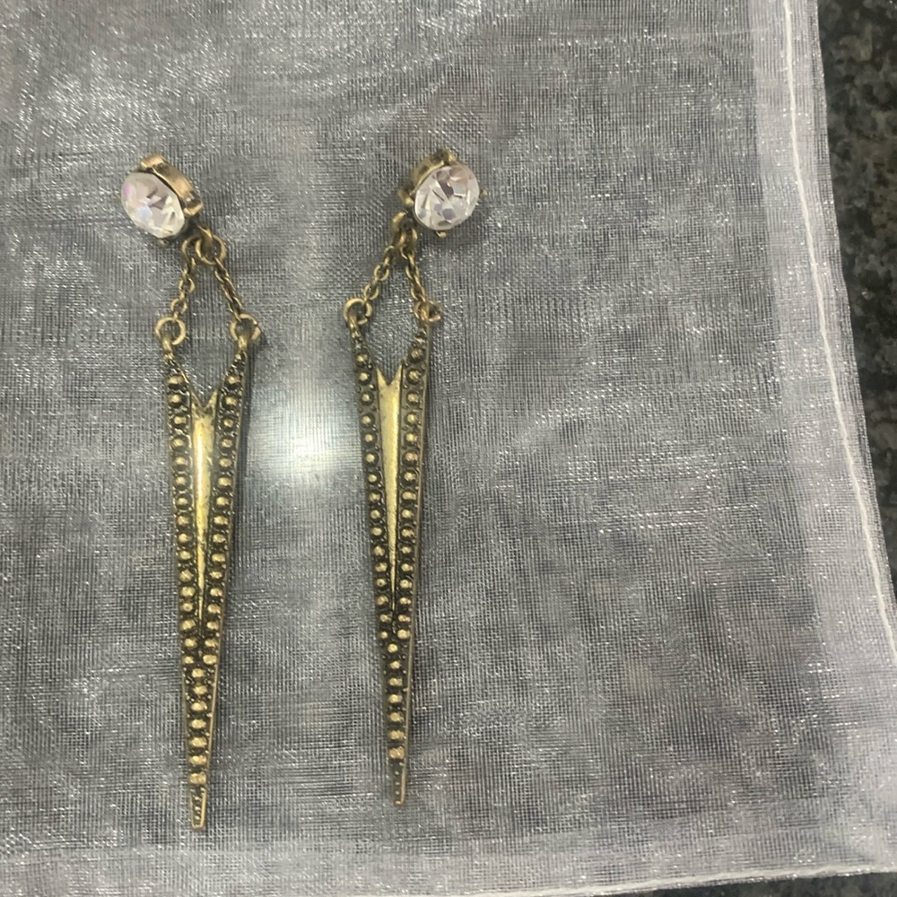 These fashion earrings are both edgy and feminine in an antique gold tone.